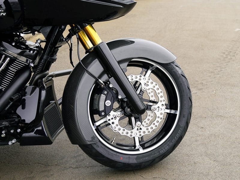 High-performance motorcycle wheel with carbon fibre fender and disc brakes for Revelry Motorcycles.