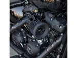 V8 black motorcycle engine with custom air filter on a sleek Harley Davidson bike.