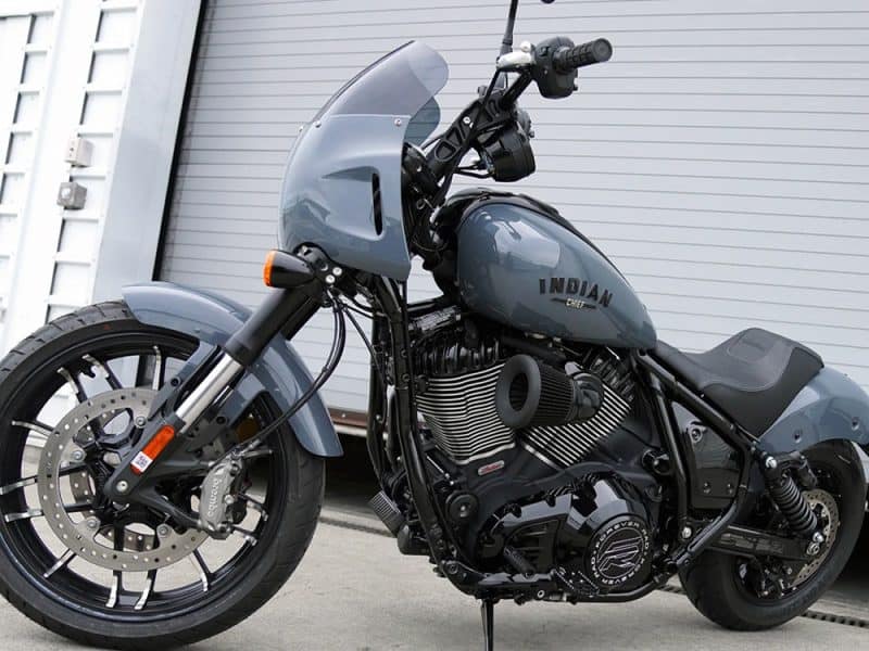 Motorcycle with custom black and grey Indian Chief design, front view in an industrial setting.