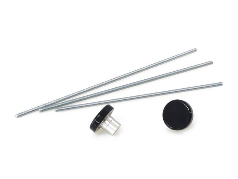 Four metal bolts with black and clear plastic caps, motorcycle maintenance parts, on white background.