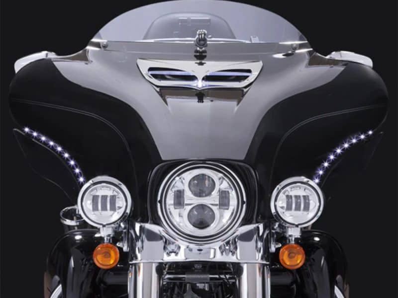 Shiny black motorcycle front view showcasing advanced LED headlights and aerodynamic design, ideal for motorcycle enthusiasts.
