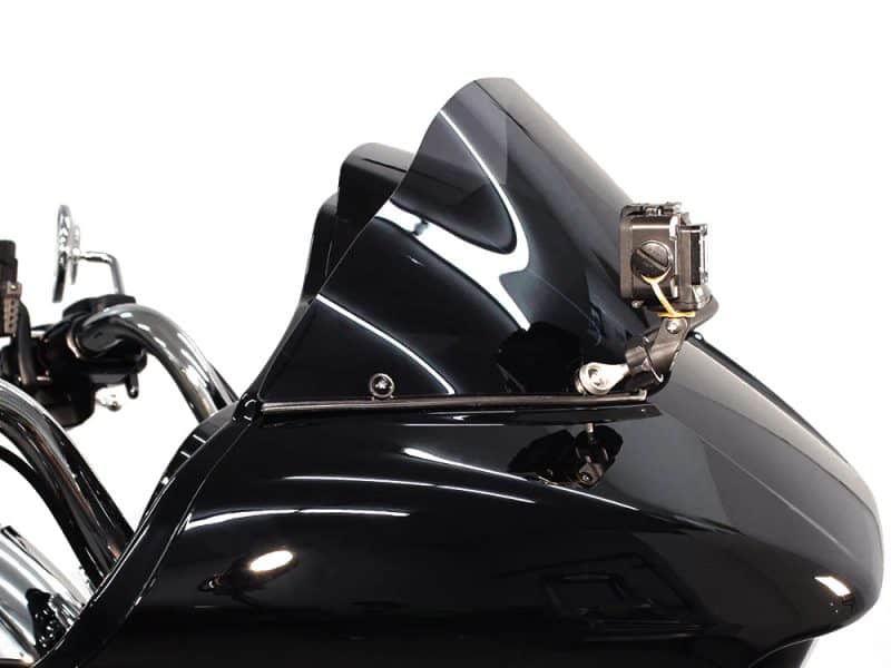 Shiny black motorcycle fairing with digital speedometer and sleek design.