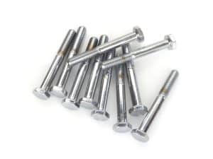 Assorted chrome motorcycle bolts on white background.