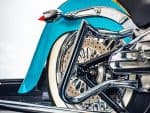 Vivid blue Harley-Davidson motorcycle with chrome exhaust and whitewall tyres.