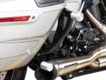 Stainless steel motorcycle exhaust system on a sleek black and chrome Revelry motorcycle.