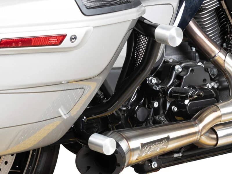 Stainless steel motorcycle exhaust system on a sleek black and chrome Revelry motorcycle.