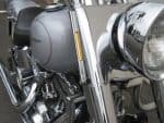 Sleek motorcycle close-up featuring chrome details and front headlight.