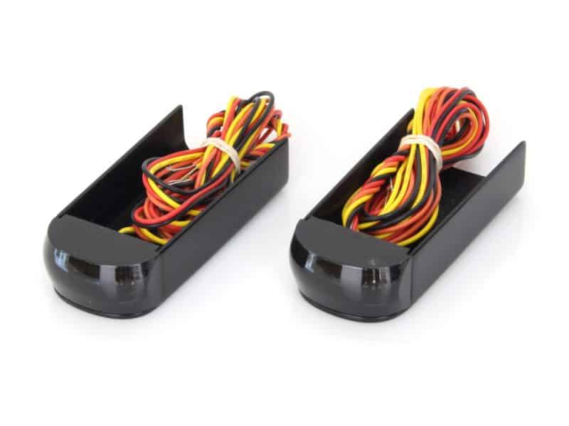 Colour-coded motorcycle wiring harnesses in black cable management trays for Revelry Motorcycles.