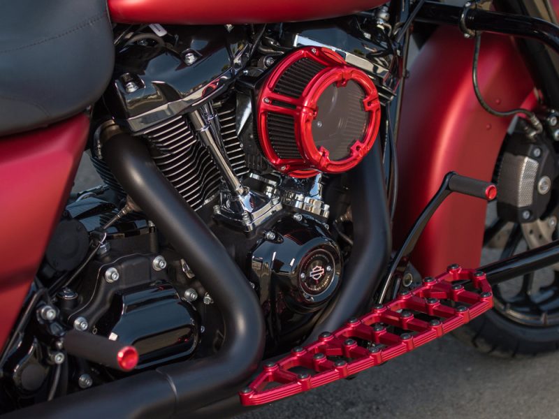 High-performance motorcycle engine with custom red accents and accessories from Revelry Motorcycles in Australia.