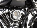 Vivid close-up of a black Harley Davidson motorcycle engine showcasing chrome details.