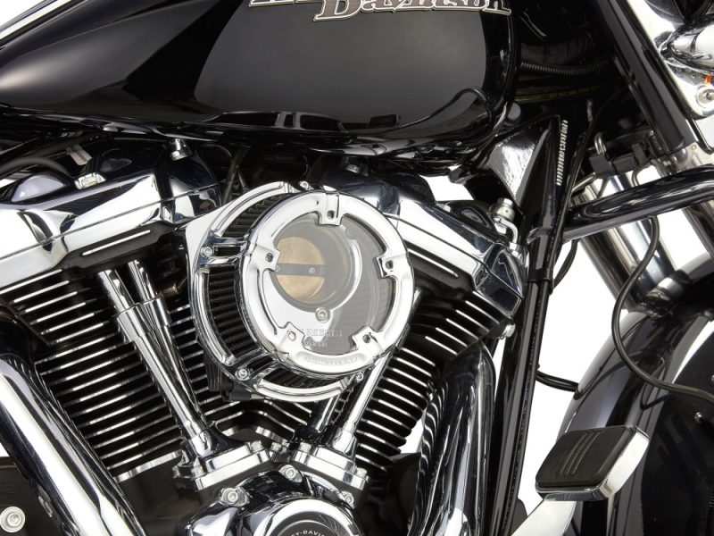Vivid close-up of a black Harley Davidson motorcycle engine showcasing chrome details.