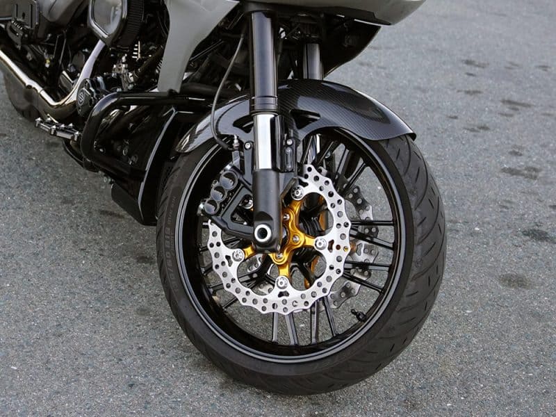 Sleek black motorcycle front wheel with gold accents, disc brake, and high-performance tires for motorcycle enthusiasts in Australia.