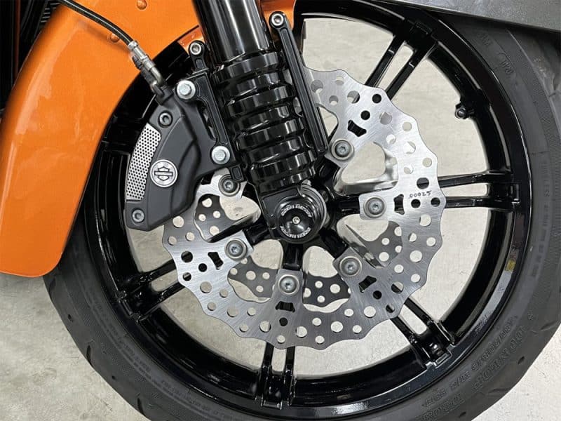 High-performance motorcycle front wheel with disc brake and suspension, ideal for Australian street bikes.