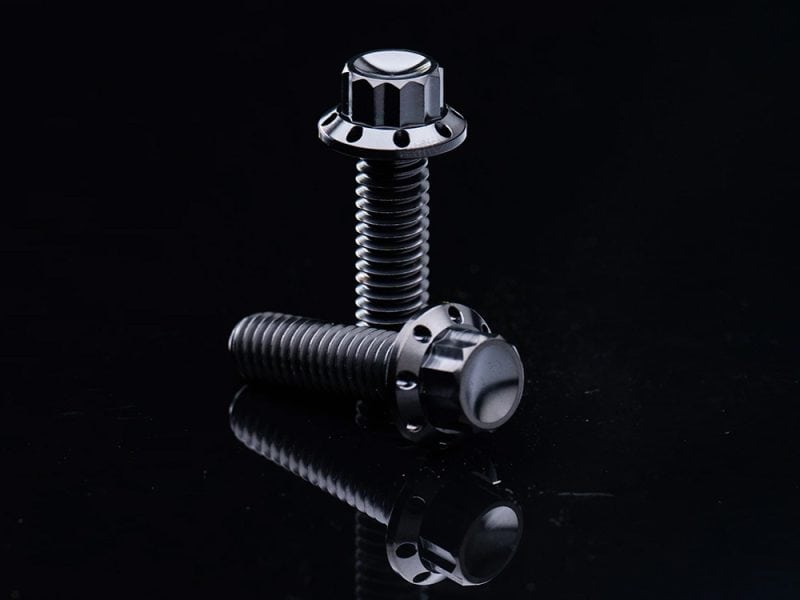 High-performance motorcycle bolt on black background.