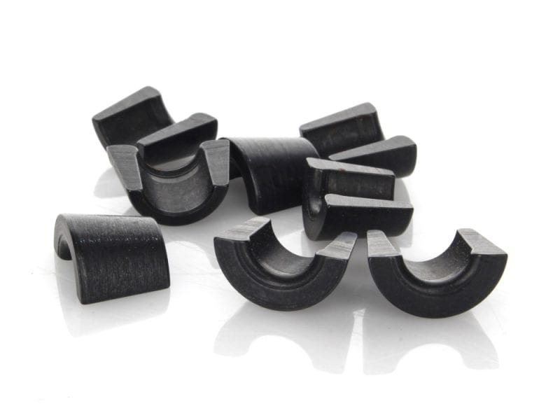 Black motorcycle engine piston clips for Harley Davidson and custom bikes.