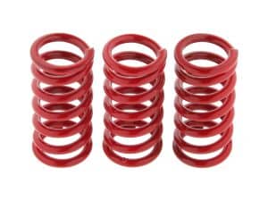 Red motorcycle coil springs for enhanced bike suspension performance.