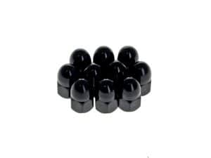 Black motorcycle axle nut covers on white background.