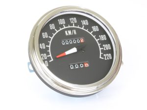 Vintage motorcycle speedometer with odometer and tachometer features.