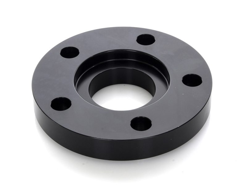 Black motorcycle wheel spacer for Revelry Motorcycles, durable, high-quality motorbike accessory.
