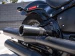 High-performance black motorcycle exhaust system at Revelry Cycles, designed for style and power.