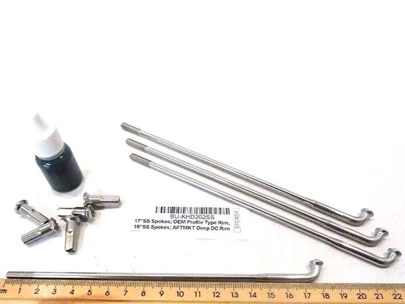 Heavy-duty motorcycle spoke removal and repair kit with spanners and oils.