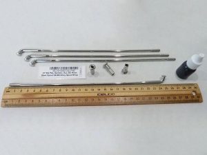 Precision motorcycle parts with metal rods and tools for custom builds.