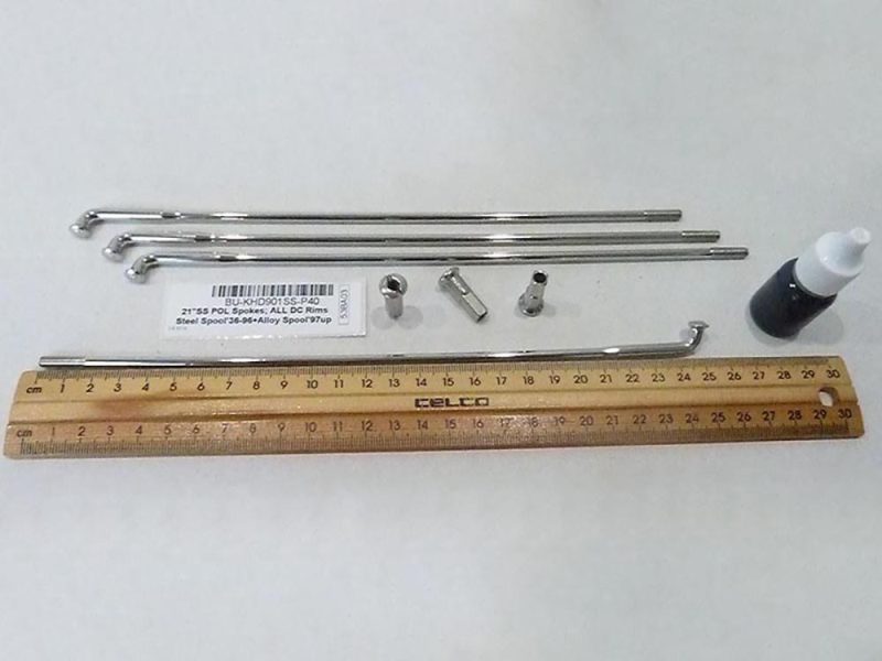 Precision motorcycle parts with metal rods and tools for custom builds.