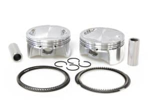 Aluminium motorcycle engine pistons with rings and pins for performance upgrades.
