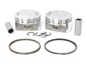 Aluminium motorcycle pistons with rings and connecting pins for Revelry Cycles custom builds.