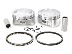 Lightweight aluminium motorcycle pistons with rings and pins for Revelry Cycles bikes.