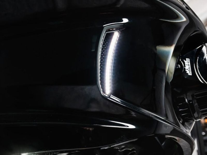 Sleek black motorcycle with LED headlight upgrade at Revelry Motorcycles, premium Australian motorcycle accessories.