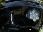 High-performance motorcycle headlight with LED lighting and sleek black design.