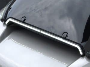 LED motorcycle brake light strip on black motorcycle, close-up of tail light.