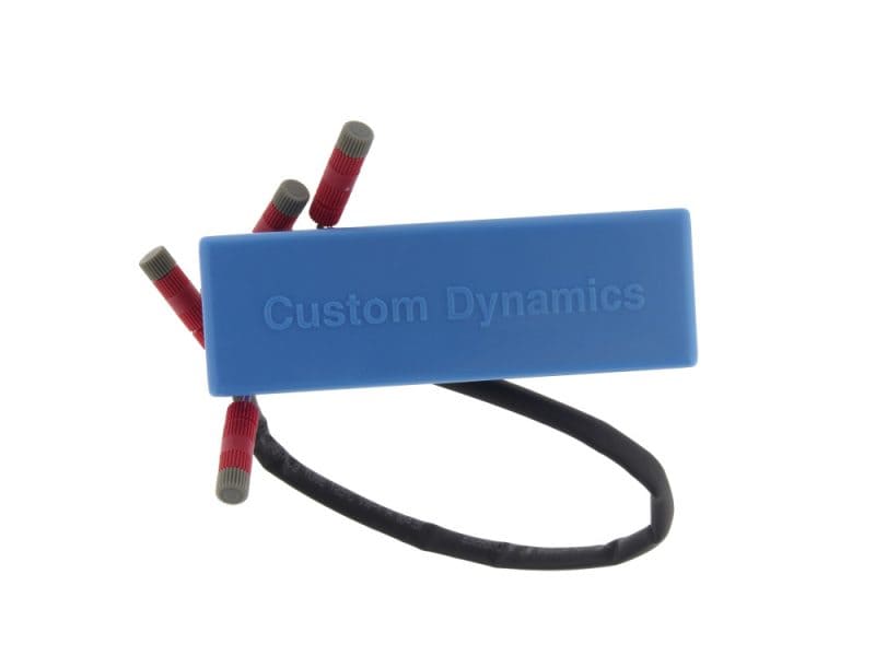 Blue motorcycle ignition coil with wiring for Revelry Motorcycles customization.