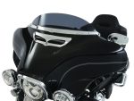 Vintage black motorcycle fairing with chrome accents and tinted windshield.