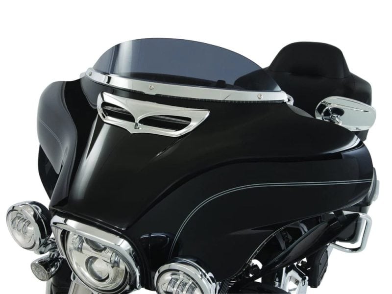 Vintage black motorcycle fairing with chrome accents and tinted windshield.