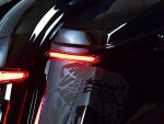Innovative motorcycle tail light with custom black decals, sleek design, safe night riding.