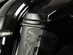 High-performance motorcycle close-up with custom decals, showcasing sleek black and silver design, perfect for Revelry Motorcycles enthusiasts.