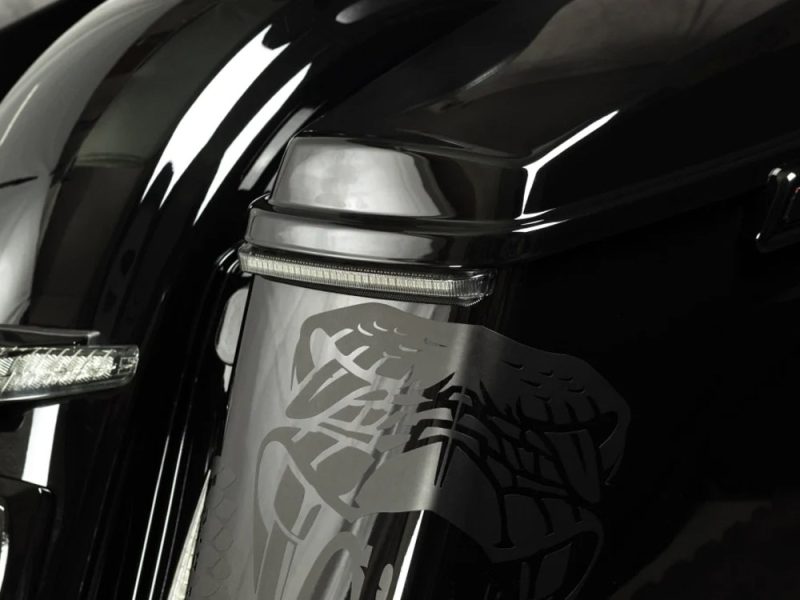 High-performance motorcycle close-up with custom decals, showcasing sleek black and silver design, perfect for Revelry Motorcycles enthusiasts.