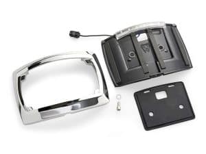 Chrome motorcycle headlight cover with electronic components and mounting hardware for Revelry Motorcycles.