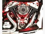 Vibrant chrome motorcycle engine with red LED accent lighting, showcasing high-performance parts.