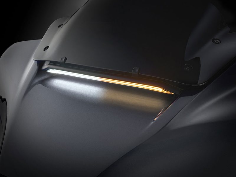 Sleek black motorcycle with modern LED lighting for optimal visibility and style.