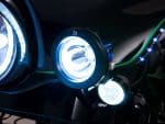 Bright LED motorcycle headlights on a black motorcycle for enhanced visibility and safety in riding.