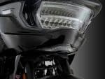 Harley Davidson motorcycle headlight with sleek black design for touring and cruising.