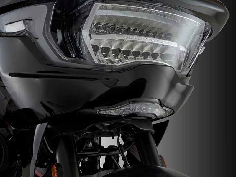 Harley Davidson motorcycle headlight with sleek black design for touring and cruising.