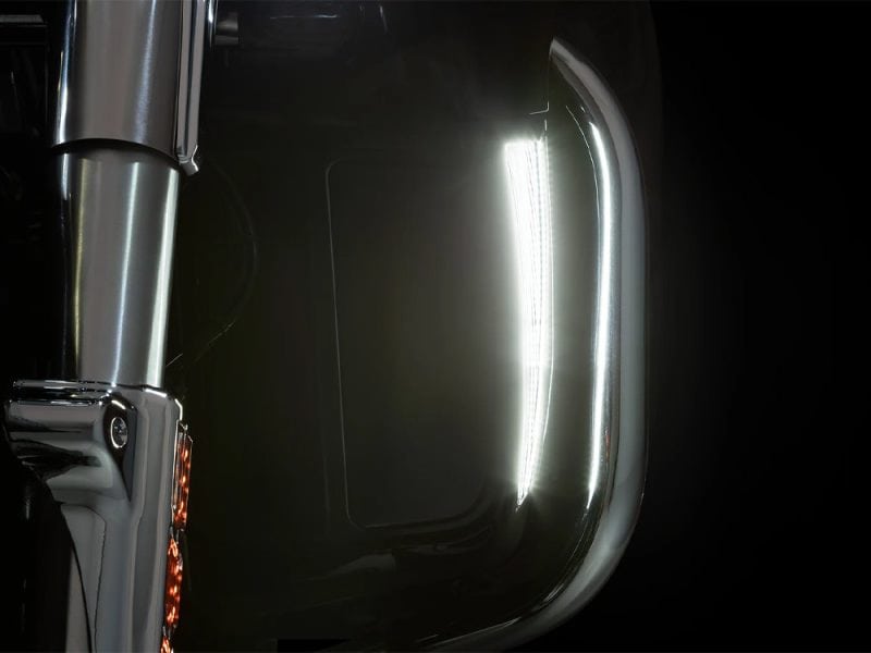 Shiny motorcycle fuel tank with chrome accents and sleek design.