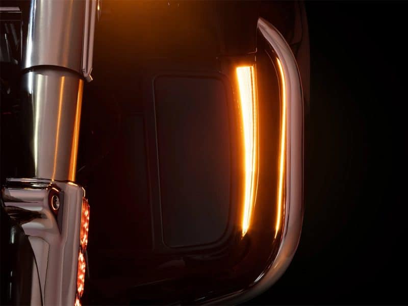 Shiny motorcycle close-up with LED lights, sleek black finish, and modern design, showcasing premium motorcycle features.