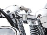 Shiny chrome motorcycle handlebar and suspension close-up.