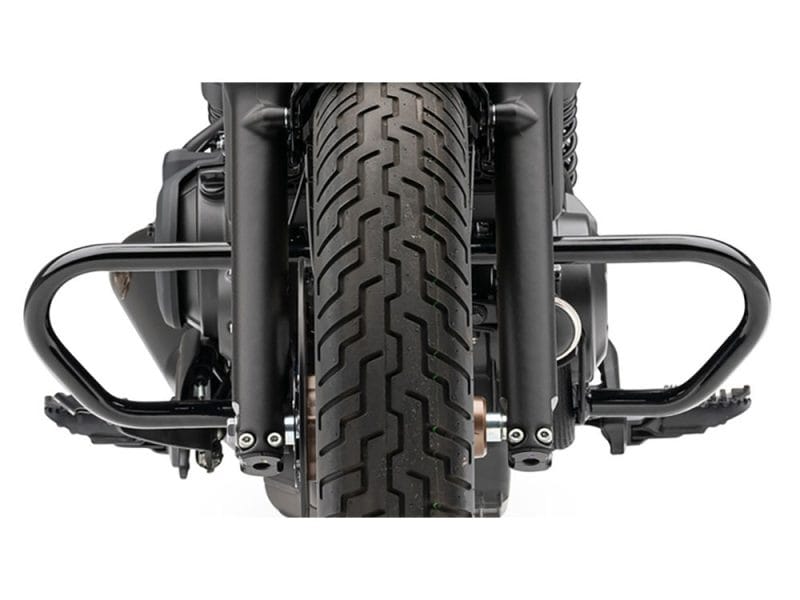 Freeway Bar - Black. Fits Honda CMX / Rebel 500cc 2017up Suspension fork and front tire of Harley Davidson motorcycle, displaying rugged design for motorcycle enthusiasts.