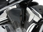 High-performance motorcycle engine with black and chrome detailing, showcasing Revelry Cycles' custom bike craftsmanship.